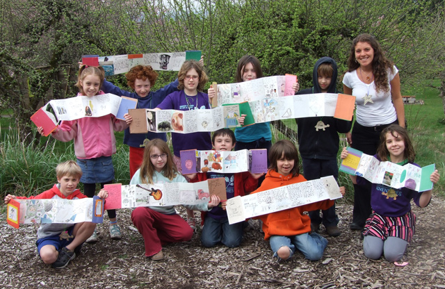 Group photo of students displaying their art projects